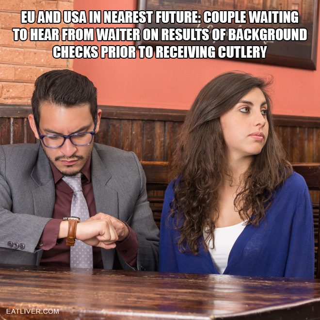Couple waiting to hear from waiter on results of background checks prior to receiving cutlery.