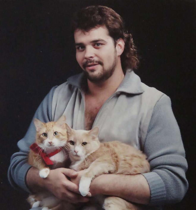 Beautiful man posing with beautiful cats.