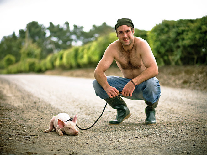 Farmer taking pig for a walk.