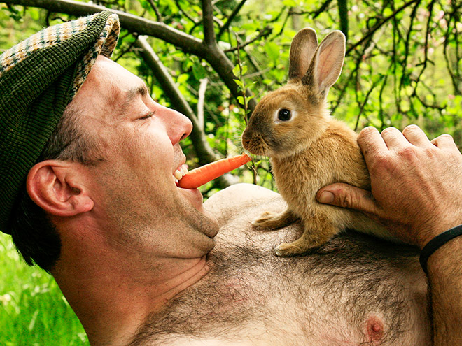 Irish farmer feeding a rabbit.
